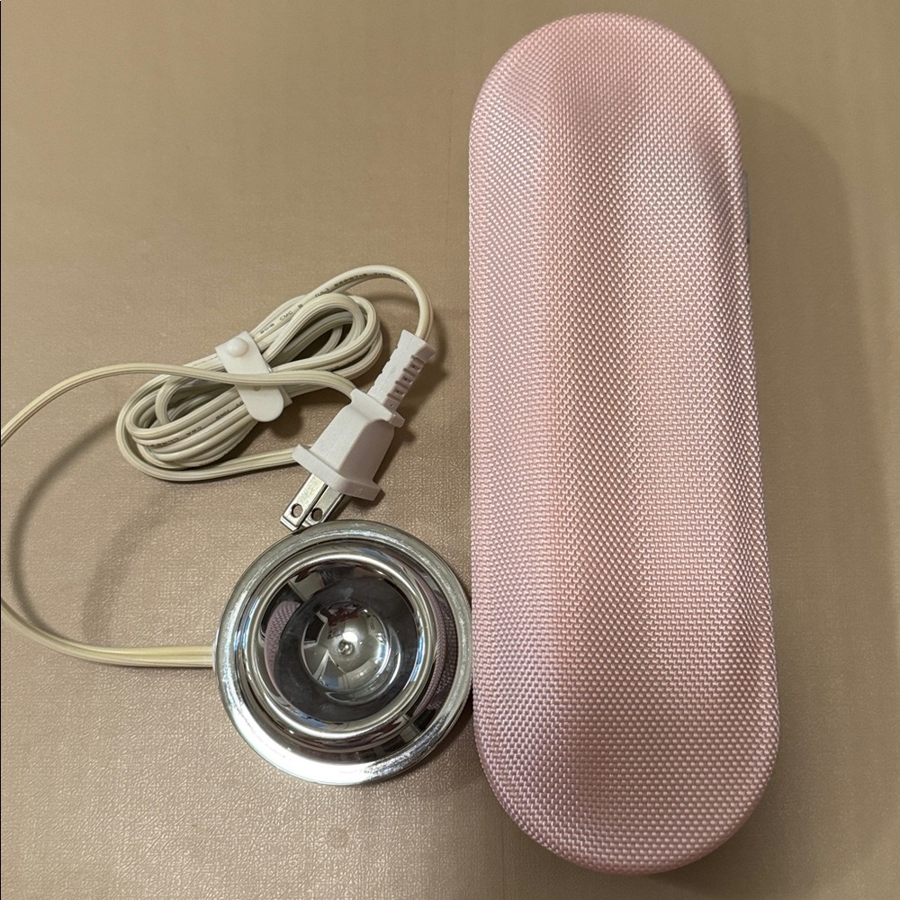Pink Philips Sonicare toothbrush travel case and home charger